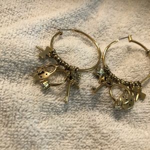 Hoop gold tone earrings with charms